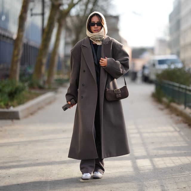 paris, france january 20 a guest wears a white hood balaclava, a brown oversized long trench coat, a brown suede bag, sneakers shoes, outside kolor, during the menswear fallwinter 20242025 as part of paris fashion week on january 20, 2024 in paris, france photo by edward berthelotgetty images