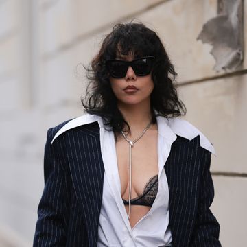 paris, france january 22 xiayan guo seen wearing denim dark blue jeans, valentino jeans shimmery bag, striped navy long coat, white blouse, black laced bra and black sunglasses outside georges hobeika during the haute couture springsummer 2024 as part of paris fashion week on january 22, 2024 in paris, france photo by jeremy moellergetty images