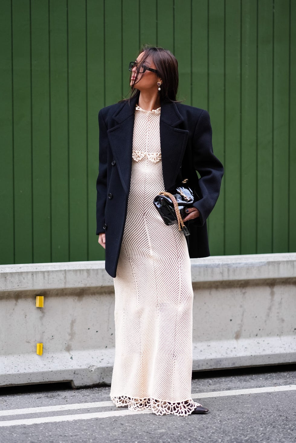 copenhagen, denmark january 31 a guest wears earrings, a black oversized blazer jacket, a white long floral embroidery with geometric patterns dress, a ysl shiny bag, outside the garment, during the copenhagen fashion week aw24 on january 31, 2024 in copenhagen, denmark photo by edward berthelotgetty images