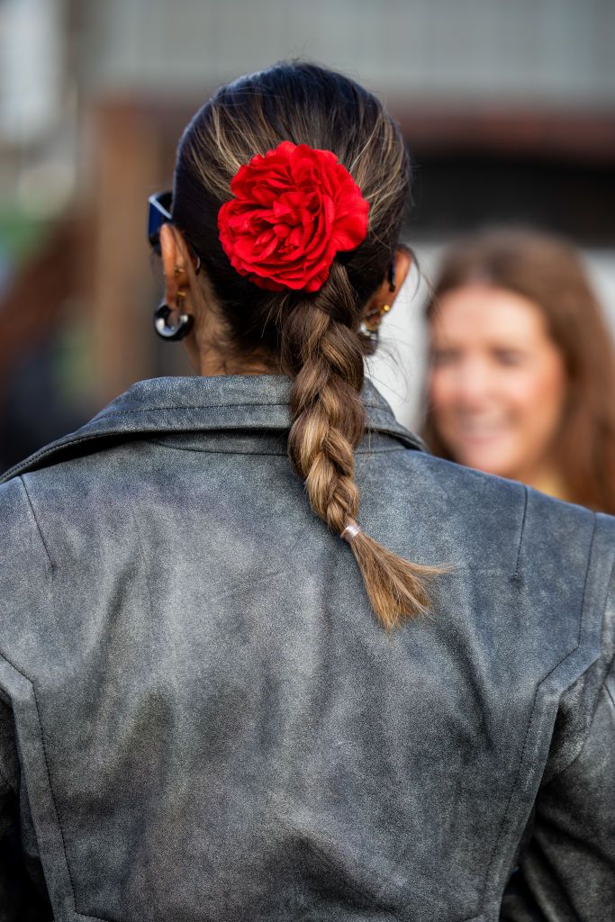 copenhagen, denmark february 01 a guest wears head hair band with flower rose outside gestuz during the copenhagen fashion week aw24 on february 01, 2024 in copenhagen, denmark photo by christian vieriggetty images