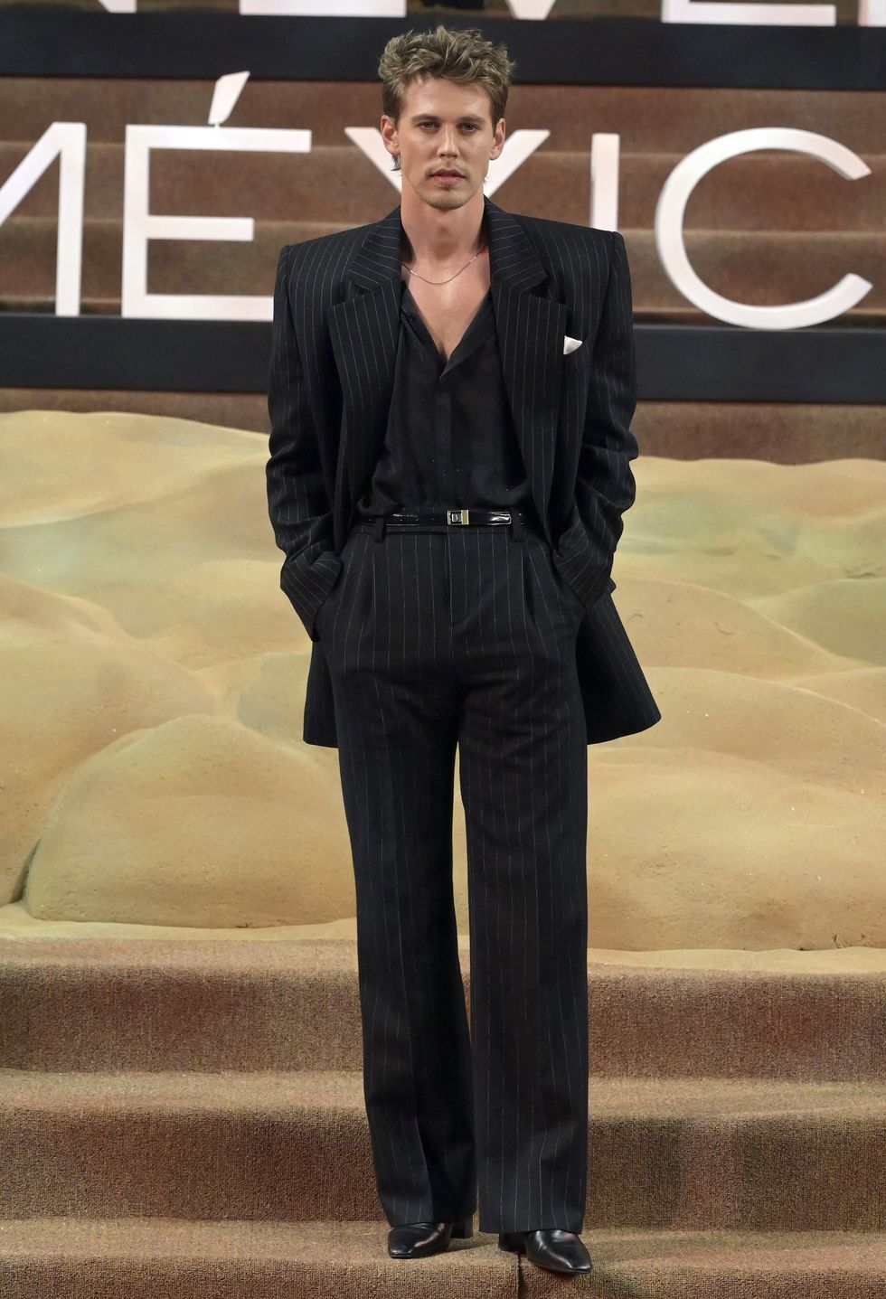 a man wearing a black suit