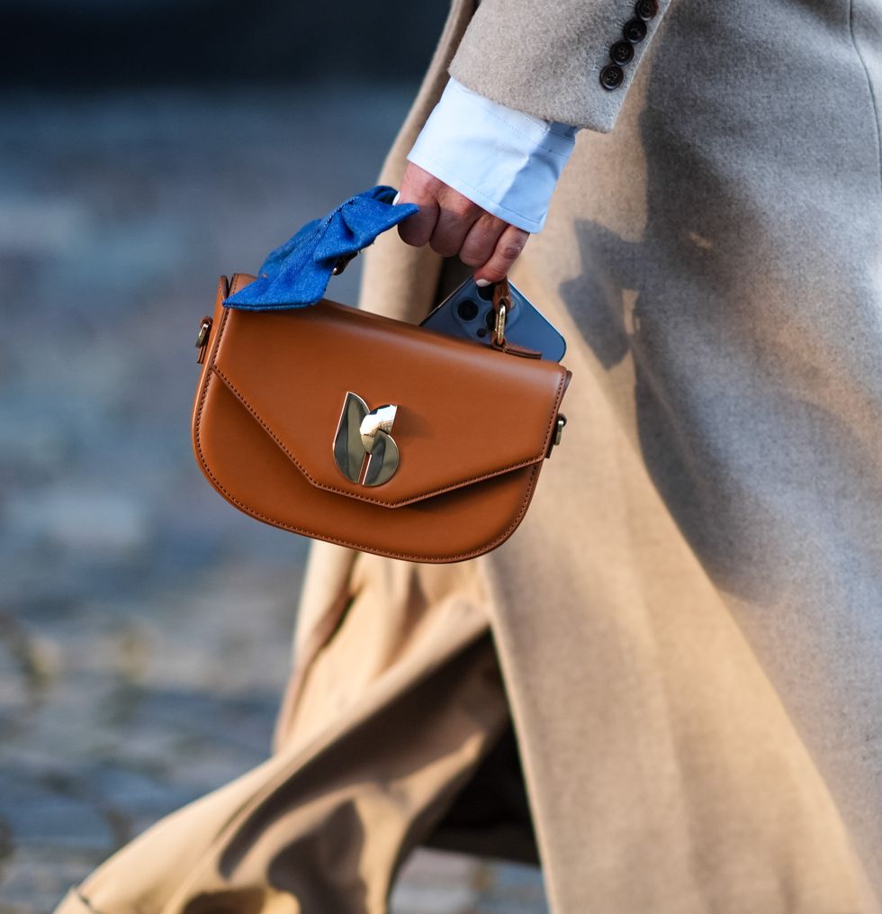 copenhagen, denmark january 31close up detail view of of a brown leather bag with a blue denim bow detail outside herskind, during the copenhagen fashion week aw24 on january 31, 2024 in copenhagen, denmark photo by edward berthelotgetty images