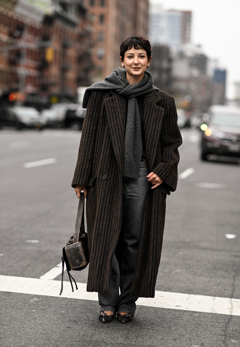 new york, new york february 10 alyssa coscarelli is seen wearing a brown and black striped coat, gray scarf, gray pants and dark green bag outside the proenza schouler show during nyfw fw 2024 on february 10, 2024 in new york city photo by daniel zuchnikgetty images