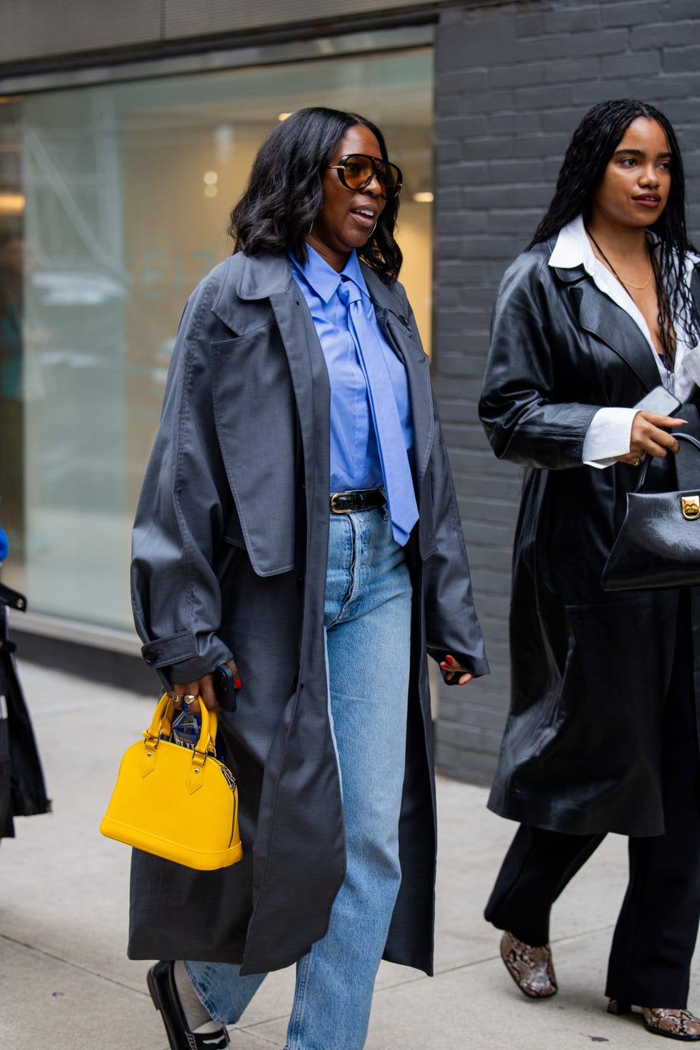 new york, new york february 10 a guest wears grey trench coat, yellow bag outside proenza schouler on february 10, 2024 in new york city photo by christian vieriggetty images