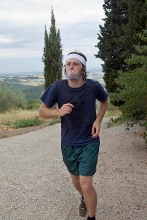 Man jogging and smoking