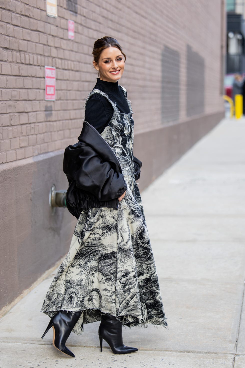 new york, new york february 11 olivia palermo wears black white dress with graphic print, bomber jacket, black turtleneck, boots outside jason wu on february 11, 2024 in new york city photo by christian vieriggetty images