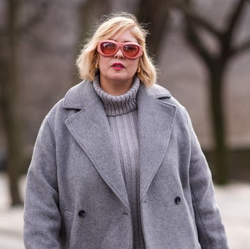 Street Style - February 2024 - New York Fashion Week new york, new york february 12 a guest wears pink sunglasses, a gray oversized turtleneck knitted ribbed wool pullover , a gray winter cotton long coat, a silver coach bag, silver gathered high heels pointed boots, outside coach, during new york fashion week, on february 12, 2024 in new york city photo by edward berthelotgetty images