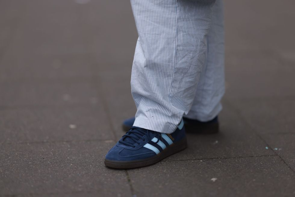 cologne, germany february 14 victoria thomas seen wearing hernameis white  blue striped long pants and adidas spezial navy blue suede leather sneakers, on february 14, 2024 in cologne, germany photo by jeremy moellergetty images