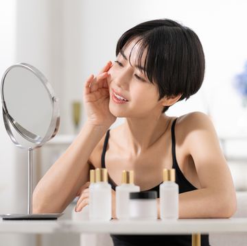 beauty of a young japanese woman looking in the mirror in the living room