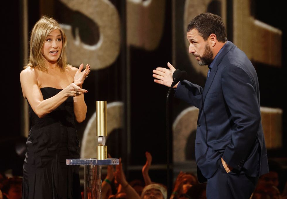 santa monica, california february 18 2024 peoples choice awards pictured l r jennifer aniston presents adam sandler with the peoples icon award onstage during the 2024 peoples choice awards held at barker hangar on february 18, 2024 in santa monica, california photo by trae pattonnbc via getty images