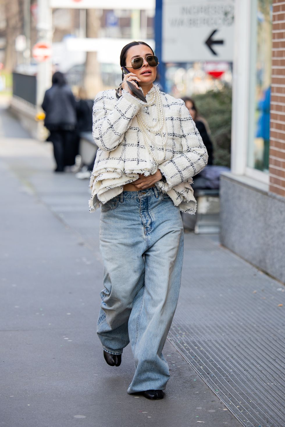 milan, italy february 21 a guest wears denim jeans, creme white checkered jacket outside fendi during the milan fashion week womenswear fallwinter 2024 2025 on february 21, 2024 in milan, italy photo by christian vieriggetty images