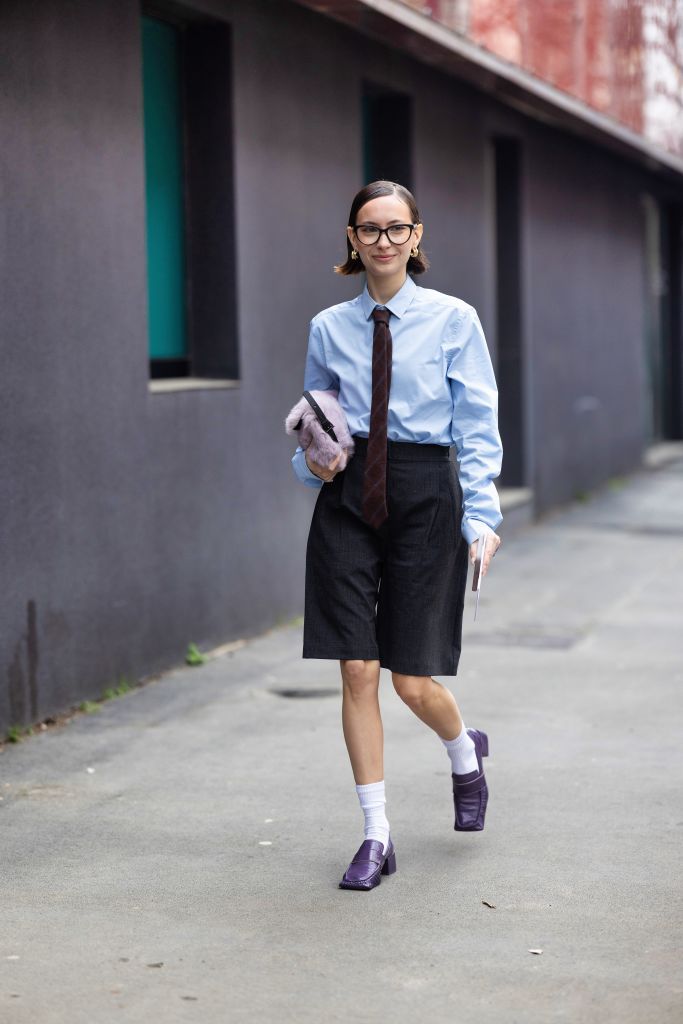 milan, italy february 22 a guest is seen wearing a light blue shirt, grey bermuda shorts, a brown and blue printed tie, white socks, a violet fur bag, gold earrings and purple leather heeled loafers outside max mara show during the milan fashion week womenswear fallwinter 2024 2025 on february 22, 2024 in milan, italy photo by valentina frugiuelegetty images