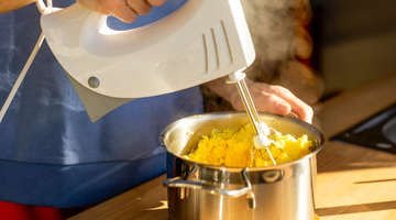 woman preparing mashed potatoes in home kitchen