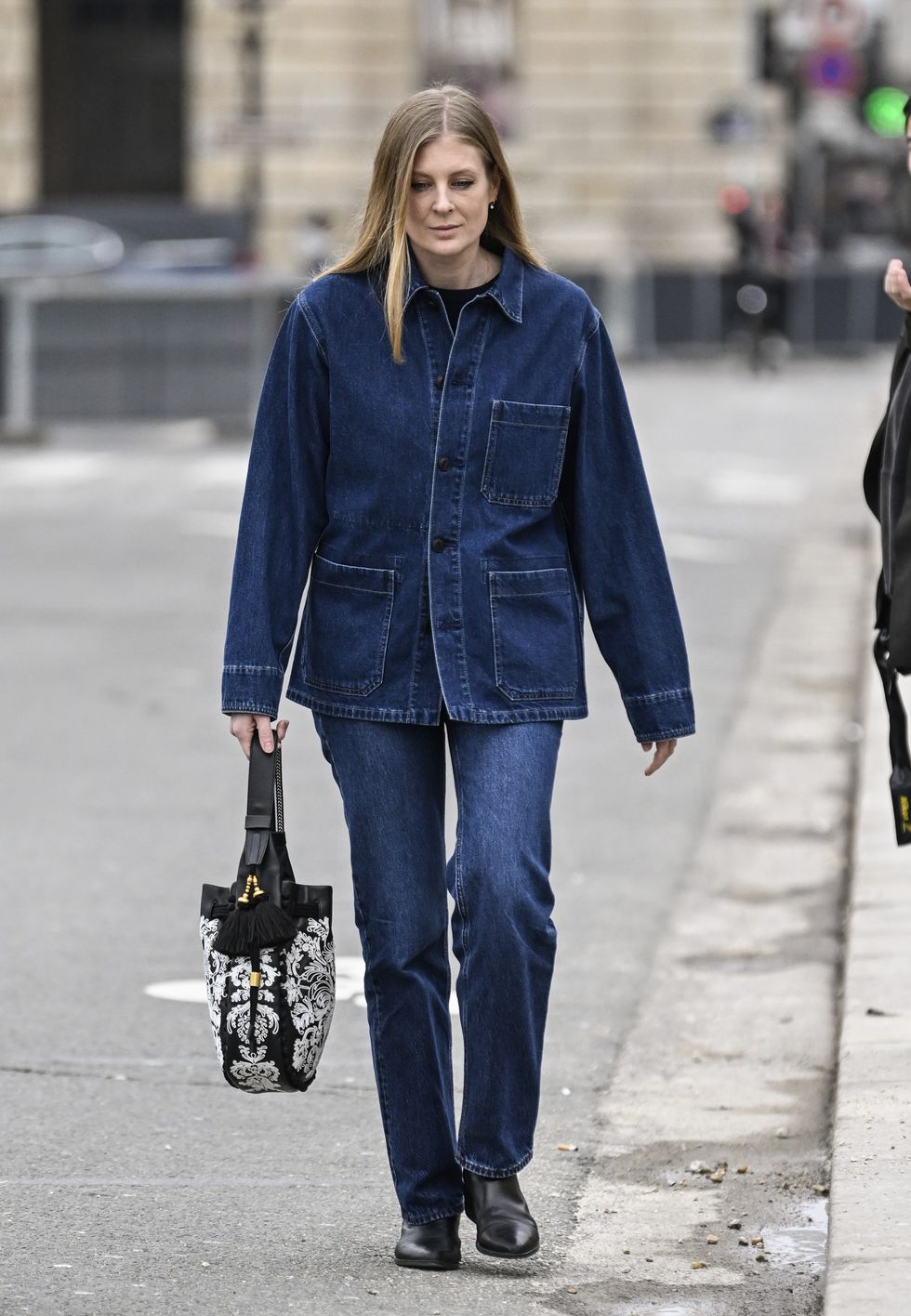 paris, france february 27 a guest is seen wearing a denim jacket, denim pants, black and white dior large bag and black boots outside the dior show during the womenswear fallwinter 20242025 as part of paris fashion week on february 27, 2024 in paris, france photo by daniel zuchnikgetty images