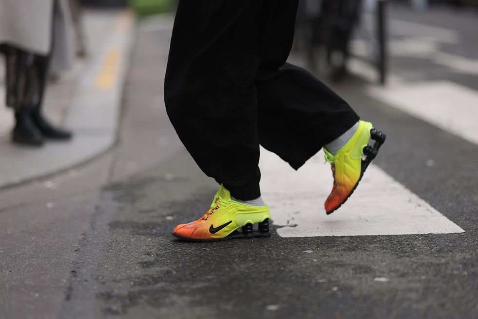 paris, france february 27 a guest seen wearing black denim baggy pants and nike x sacai orange  yellow sneakers, outside mame kurogouchi, during the womenswear fallwinter 20242025 as part of paris fashion week on february 27, 2024 in paris, france photo by jeremy moellergetty images