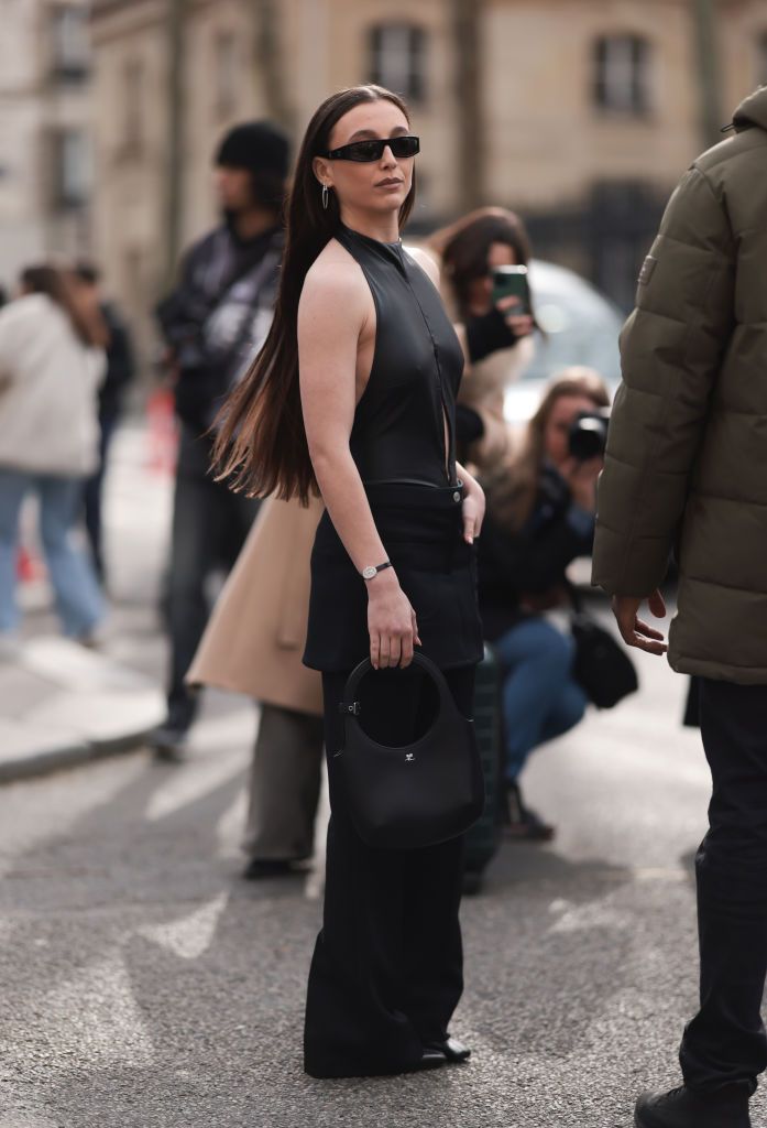 paris, france february 28 emma chamberlain was seen wearing black leather shoes,black trousers, black courreges shades, a black courreges bag, silver jewelry as well as a leather top with a slit on the belly before courreges fashion show during the womenswear fallwinter 20242025 as part of paris fashion week on february 28, 2024 in paris, france photo by jeremy moellergetty images