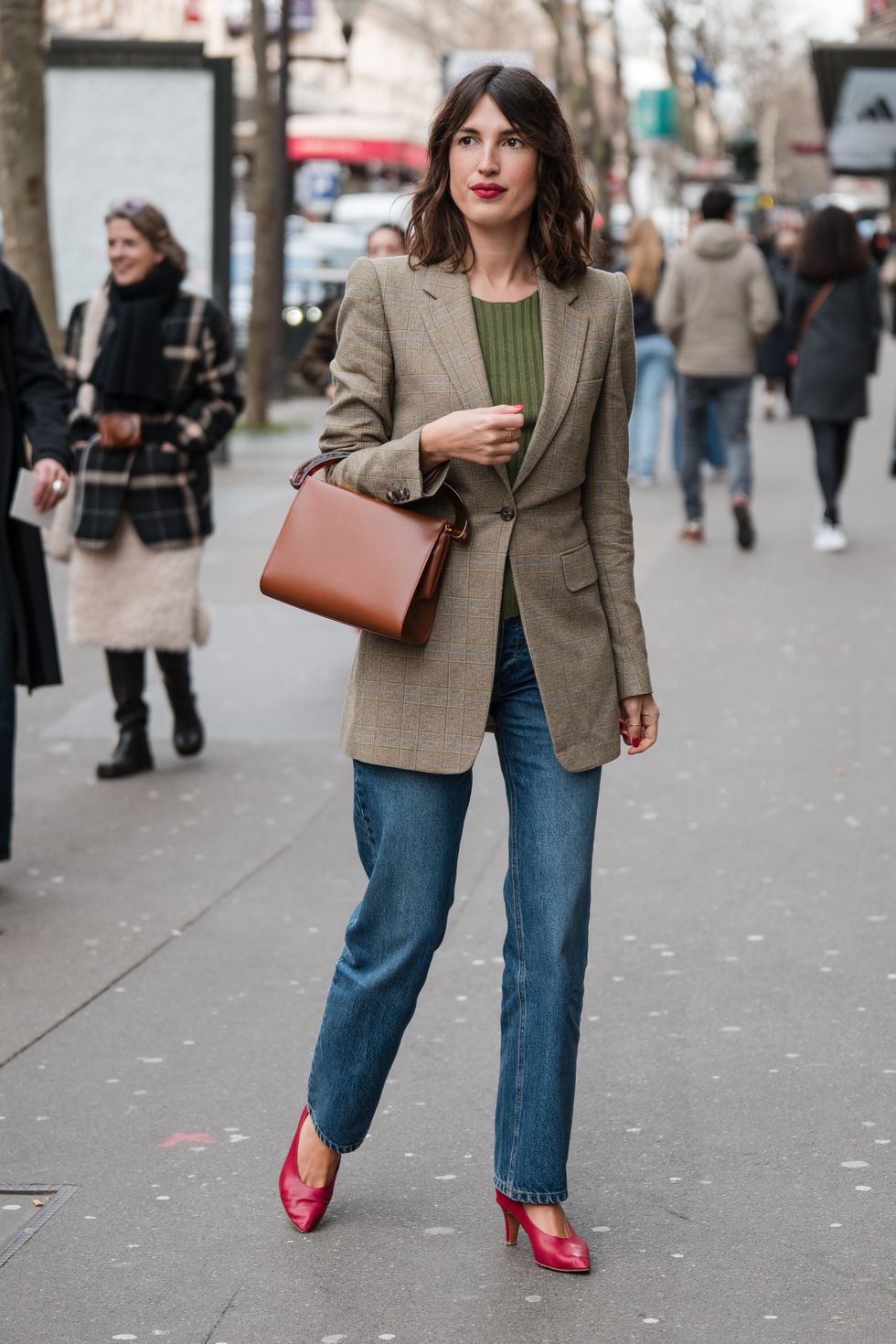 paris, france february 28 jeanne damas wears green top, beige checked blazer, jeans, brown bag, red heels, outside dries van noten, during the womenswear fallwinter 20242025 as part of paris fashion week on february 28, 2024 in paris, france photo by claudio laveniagetty images