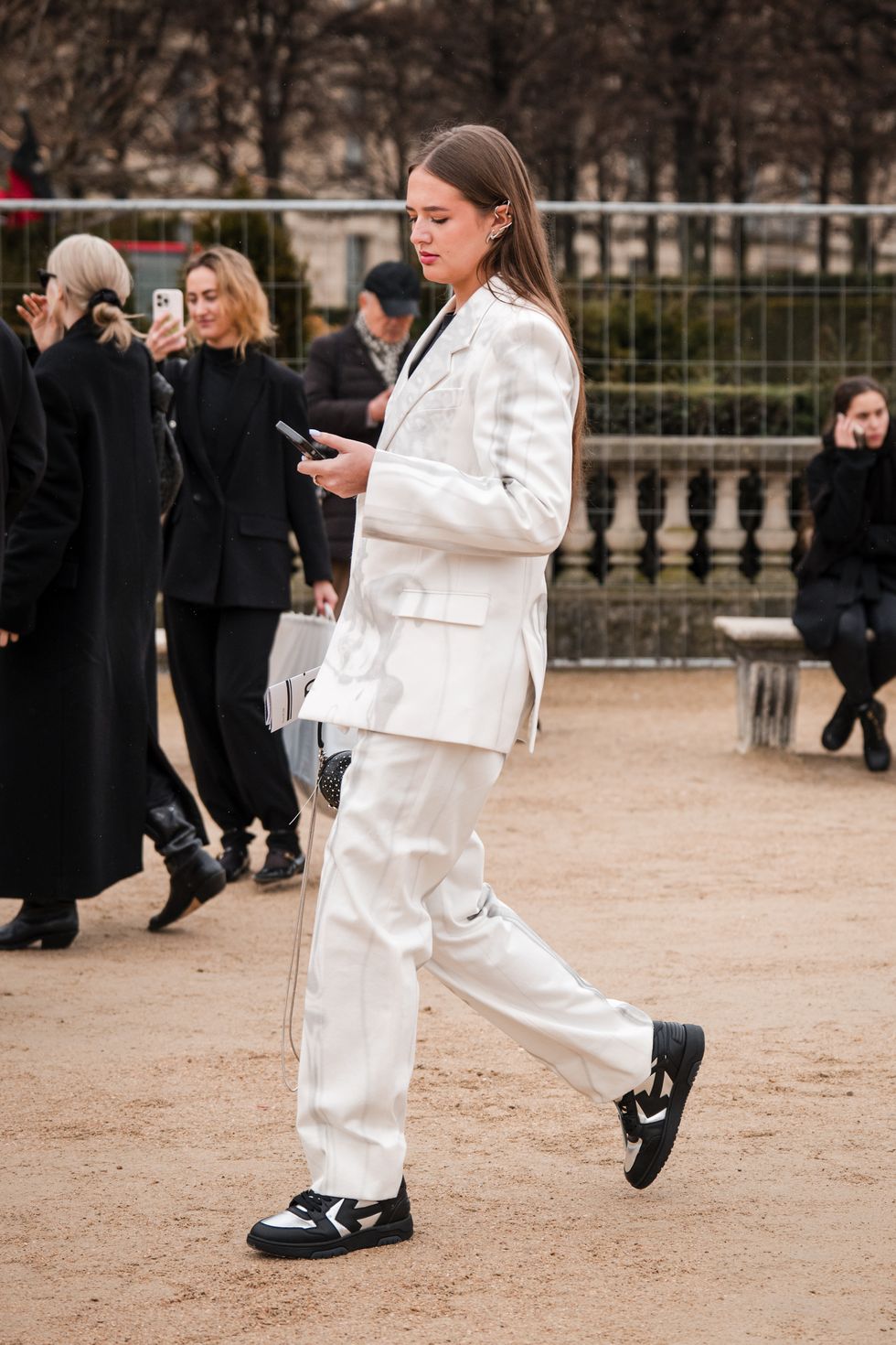 paris, france february 29 a guest wears cream printed suit, black and silver off white sneakers, outside off white, during the womenswear fallwinter 20242025 as part of paris fashion week on february 29, 2024 in paris, france photo by claudio laveniagetty images