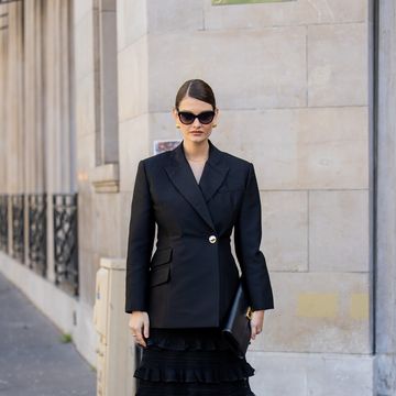 paris, france march 04 hanneli mustaparta wears black tailored blazer, black ruffled skirt, long bag, heeled sandals with flower, sunglasses outside zimmermann during the womenswear fallwinter 20242025 as part of paris fashion week on march 04, 2024 in paris, france photo by christian vieriggetty images