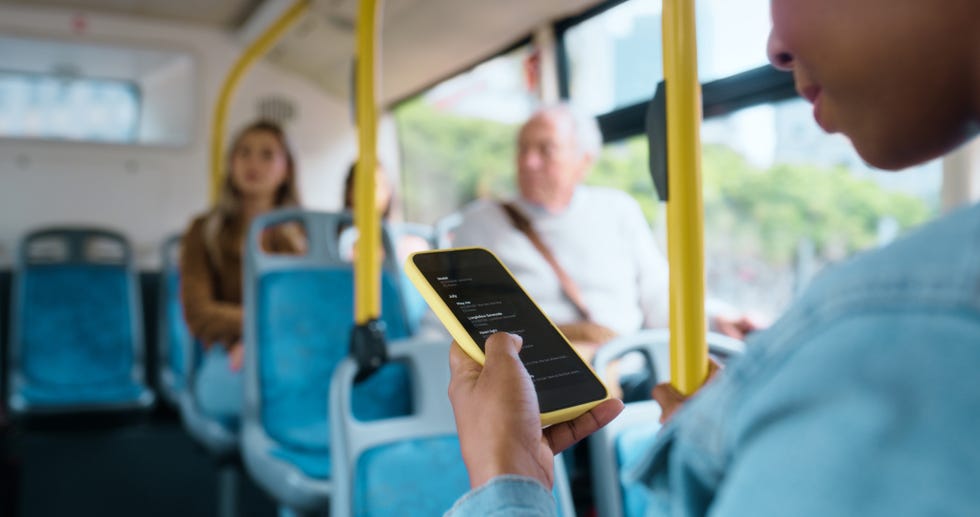 person or smartphone on public transport