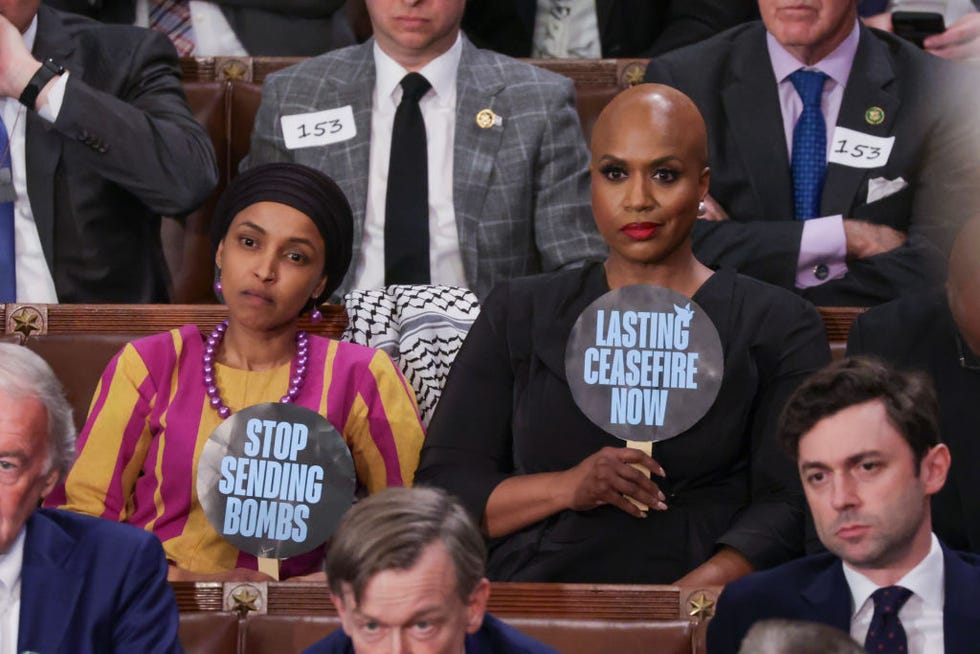 washington, dc march 07 us rep ilhan omar d mn l and rep ayanna pressley d ma hold up signs as president joe biden delivers the state of the union address during a joint meeting of congress in the house chamber at the us capitol on march 07, 2024 in washington, dc this is biden’s last state of the union address before the general election this coming november photo by alex wonggetty images