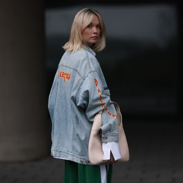 munich, germany march 06 nadine berneis seen wearing balenciaga light blue oversized logo denim jeans jacket, black palms the label white cotton oversized buttoned shirt, karo kaur label green white wide leg pants, gucci beige creamy white leather bag, on march 06, 2024 in munich, germany photo by jeremy moellergetty images