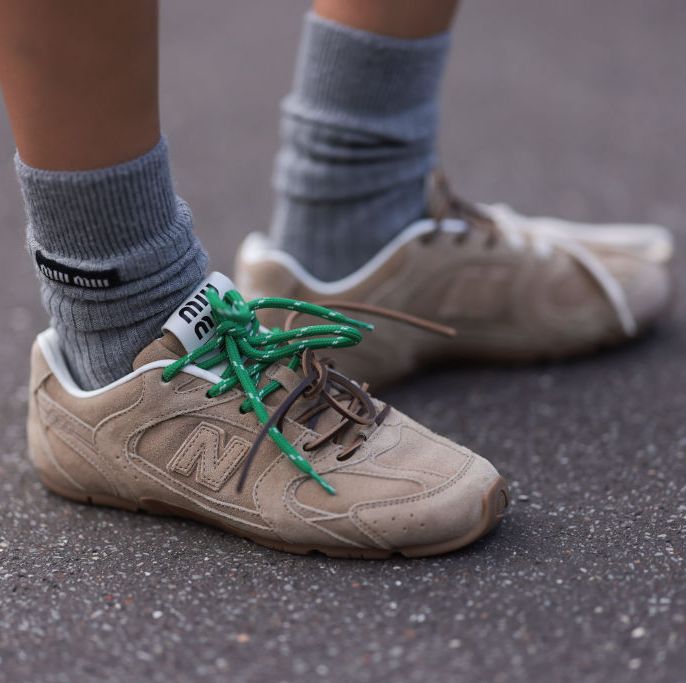 paris, france march 05 a guest seen wearing miu miu x new balance beige sneaker and miu miu grey wool socks outside miu miu show during the womenswear fallwinter 20242025 as part of paris fashion week on march 05, 2024 in paris, france photo by jeremy moellergetty images