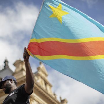 a demonstrator of the congolese civil society of south africa waves a national flag of democratic republic of congo as he takes part in a march to parliament to protest against genocide and extraction in the democratic republic of congo, in cape town, on march 16, 2024 photo by gianluigi guercia  afp photo by gianluigi guerciaafp via getty images