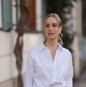 munich, germany march 22 marlies pia pfeifhofer seen wearing gold earrings and necklace, lamarel white cotton buttoned blouse shirt, agolde beige long pants, on march 22, 2024 in munich, germany photo by jeremy moellergetty images