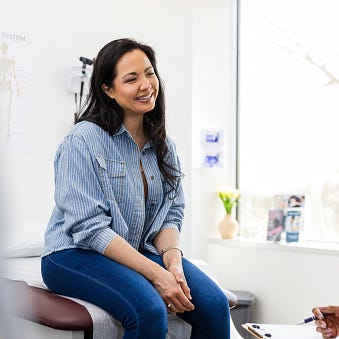 the mid adult woman sees her mid adult female doctor for her yearly well woman check up the mid adult woman sees her mid adult female doctor for her yearly well woman check up