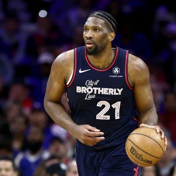 a basketball player holding a basketball