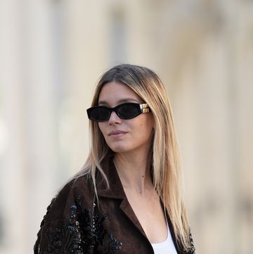 paris, france april 13 natalia verza wears sunglasses , a full miu miu look, a low neck tank top in white , a brown oversize jacket with shiny details sequins, during a street style fashion photo session, on april 13, 2024 in paris, france photo by edward berthelotgetty images
