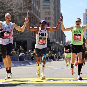 boston, massachusetts april 15 2014 boston marathon champion meb keflezighi of the united states crosses the finish line with guy gibson and immanuel wineman during the 128th boston marathon on april 15, 2024 in boston, massachusetts photo by paul rutherfordgetty images