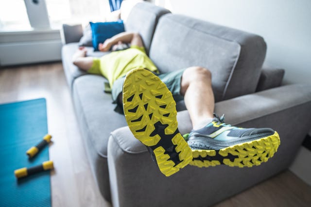 tired mature man resting on sofa after the morning workout