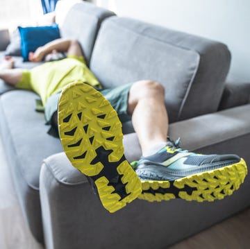 tired mature man resting on sofa after the morning workout tired mature man resting on sofa after the morning workout