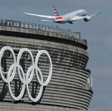 this photograph taken in roissy en france on april 23, 2024, shows the olympic rings on the roissy charles de gaulle airport terminal 1, as an aircraft takes off the paris 2024 olympics will take place from july 26 to august 11, 2024 photo by miguel medina  afp photo by miguel medinaafp via getty images
