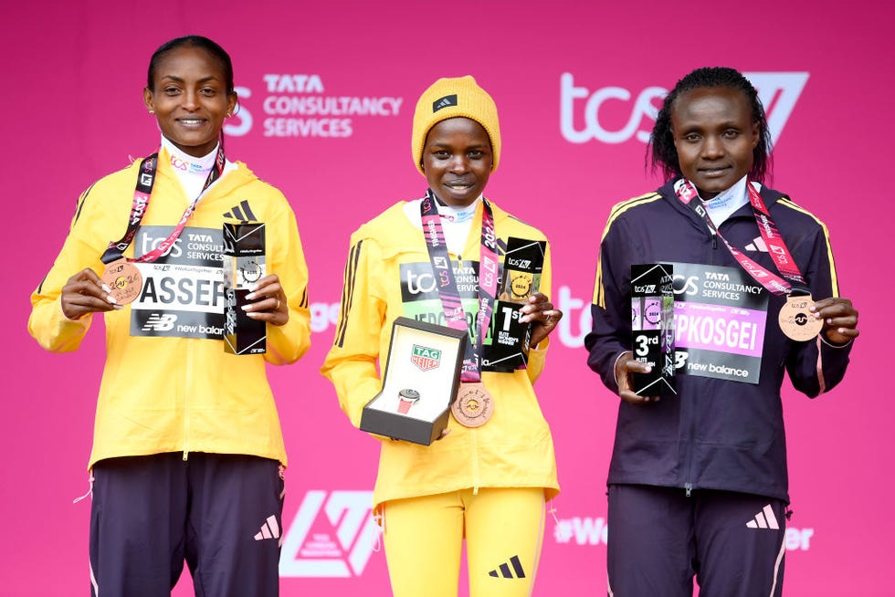 london, england april 21 l to r second placed tigst assefa of ethipoia, first placed peres jepchirchir of kenya and third placed joyciline jepkosgei of kenya celebrate on the podium after the womens elite race and setting a new world record during the 2024 tcs london marathon on april 21, 2024 in london, england photo by alex davidsongetty images