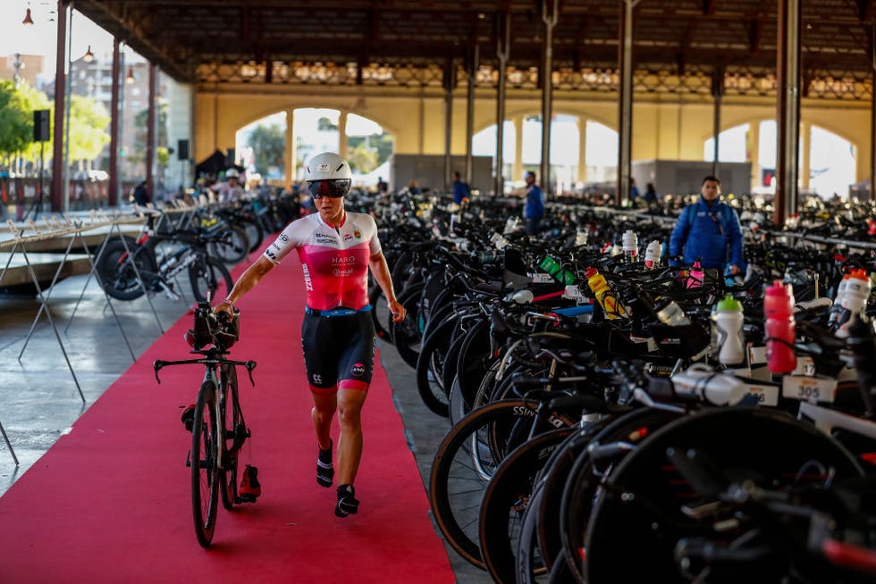 valencia, spain april 21 an athlete pushes her bike along the transition area during ironman 703 valencia on april 21, 2024 in valencia, spain photo by pablo blazquez dominguezgetty images for ironman