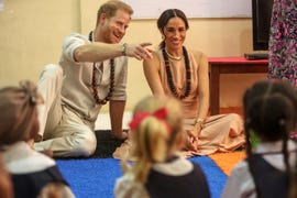 britain's prince harry (l), duke of sussex, and britain's meghan (r), duchess of sussex, meet with children during their visit at the lightway academy in abuja on may 10, 2024 as they visit nigeria as part of celebrations of invictus games anniversary. (photo by kola sulaimon / afp)