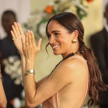 britains meghan, duchess of sussex, gestures as she arrives with britains prince harry unseen, duke of sussex, during their visit at the lightway academy in abuja on may 10, 2024 as they visit nigeria as part of celebrations of invictus games anniversary photo by kola sulaimon afp photo by kola sulaimonafp via getty images