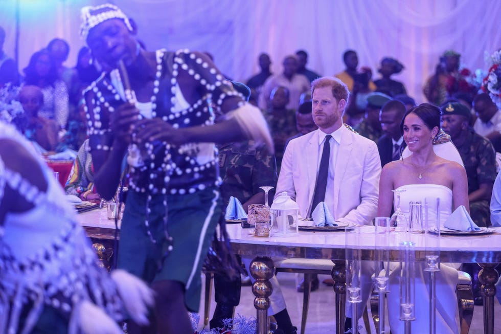 britains prince harry 2nd r, duke of sussex, and britains meghan r, duchess of sussex, look at performers dancing as they attend a sit out at the nigerian defence headquarters in abuja on may 11, 2024 as they visit nigeria as part of celebrations of invictus games anniversary photo by kola sulaimon  afp photo by kola sulaimonafp via getty images