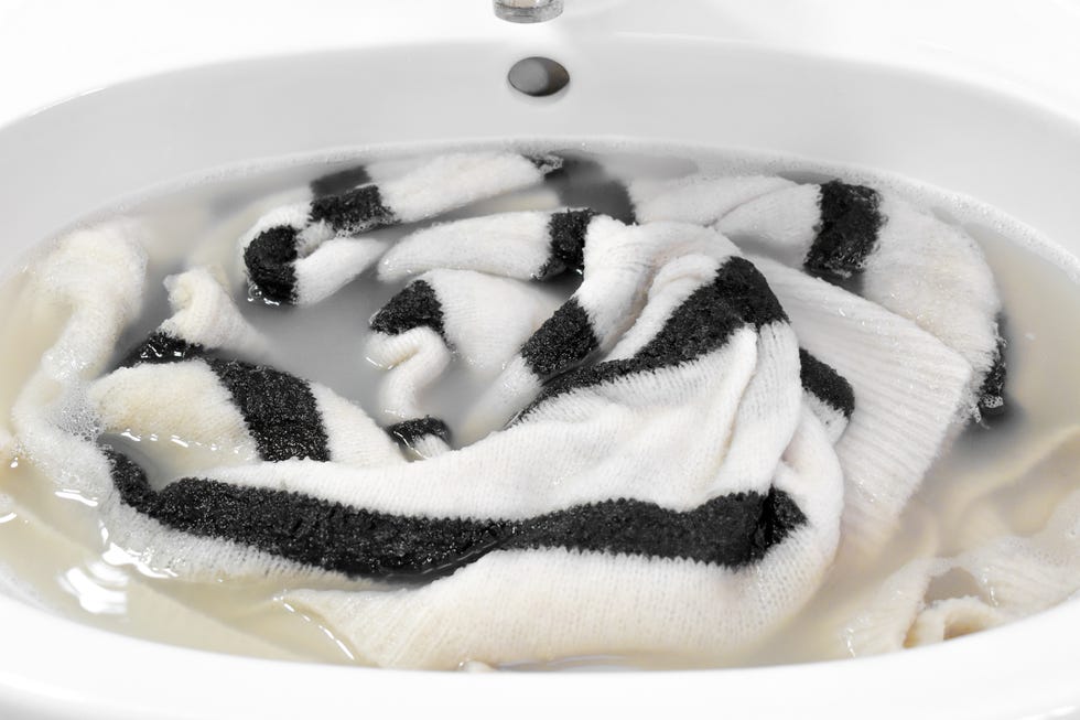 hand washing sweater in the sink