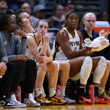basketball players and coaching staff on the bench during a game basketball players and coaching staff on the bench during a game