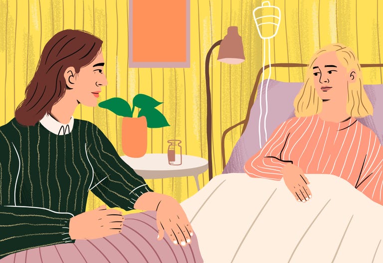 Two women in a hospital room one sitting next to the other in a bed