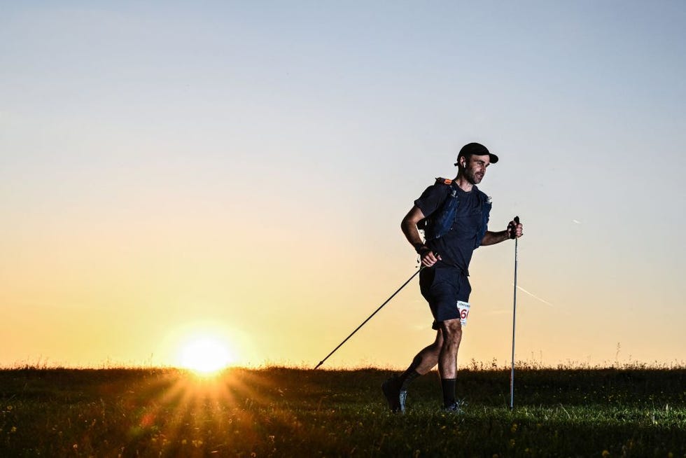 guy shepherd runs in the sunset as he competes in the centurion south downs way 100 ultramarathon at devils dyke near brighton, south of london, on june 8, 2024 the centurion south downs way 100, is an ultramarathon, predominantly off road course, covering a distance of 100 miles 160,9 kilometres and that takes the competitors along the south downs way from winchester in hampshire to eastbourne in east sussex photo by ben stansall  afp photo by ben stansallafp via getty images