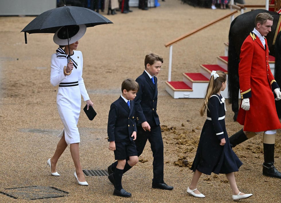 britains catherine, princess of wales, shelters from the rain with an umbrella as she walks with her children britains prince george of wales c, britains princess charlotte of wales r and britains prince louis of wales back to the glass state coach at horse guards parade during the kings birthday parade trooping the colour in london on june 15, 2024 catherine, princess of wales, is making a tentative return to public life for the first time since being diagnosed with cancer, attending the trooping the colour military parade in central london photo by justin tallis  afp photo by justin tallisafp via getty images