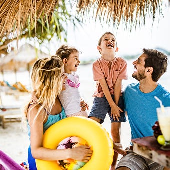 young happy family talking while spending a summer day in a caf eacute on the beach young happy family talking while spending a summer day in a caf eacute on the beach