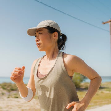 woman in sport's clothing, jogging by the sea woman in sport's clothing, jogging by the sea