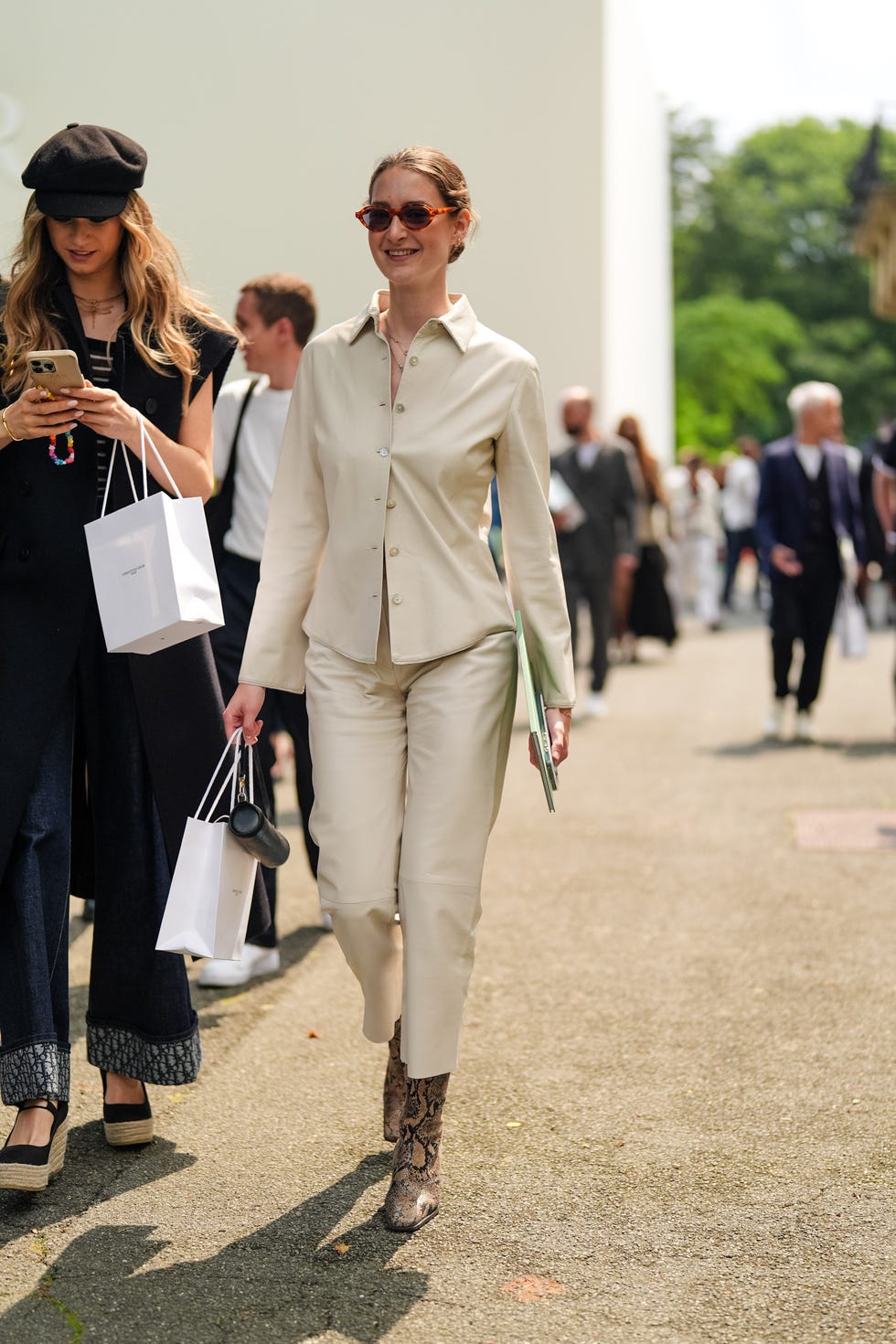 paris, france june 21 a guest wears red sunglasses, cream button up long sleeve shirt, cream straight fitted capri pants, shiny black and brown animal patternprint heels leather shoes, small black leather bag, outside dior homme, during the paris fashion week menswear springsummer 2025 on june 21, 2024 in paris, france photo by edward berthelotgetty images