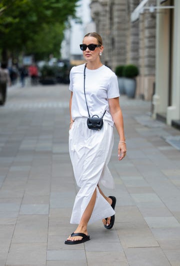 woman wearing a white outfit with black flip flops